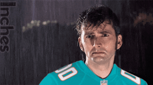 a man wearing a miami dolphins jersey with the number 10 on the front