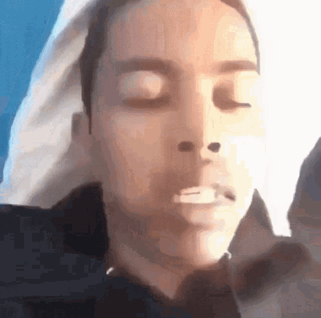 a close up of a person 's face with their eyes closed .