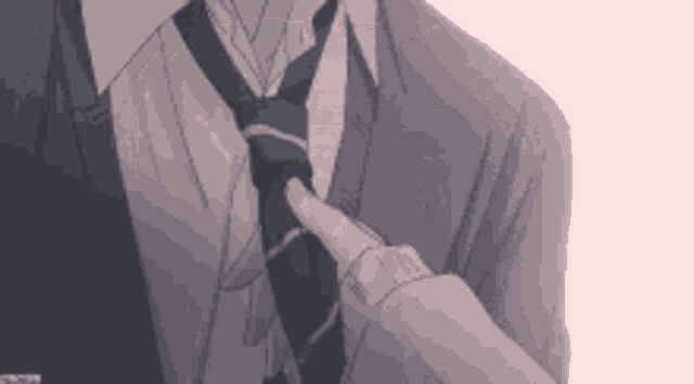 a man in a suit and tie is fixing his tie with his finger .