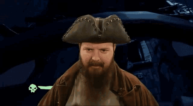 a man with a beard wearing a hat salutes
