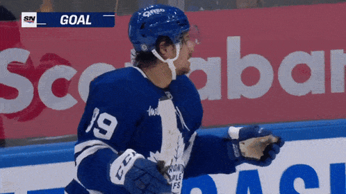 a hockey player in a blue jersey with the number 19 on it
