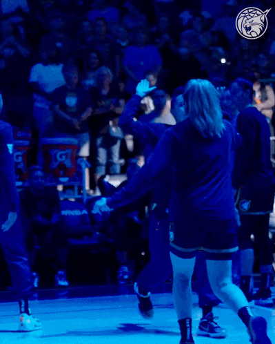 a gatorade bucket sits behind a basketball player on the court