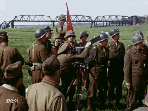 a group of soldiers are gathered in a field with ikronos media written on the bottom right
