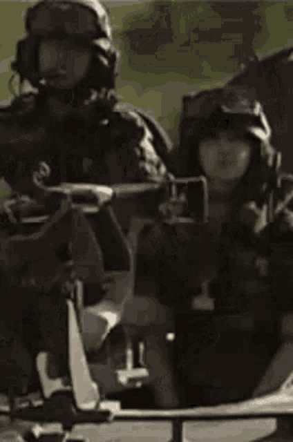 a person wearing a helmet and goggles is giving a peace sign while sitting in a chair .