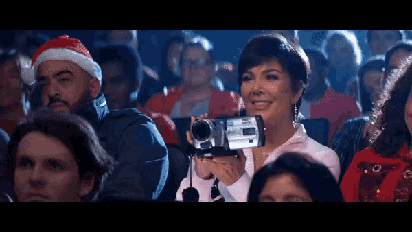 a woman is holding a camcorder that says sony on the front