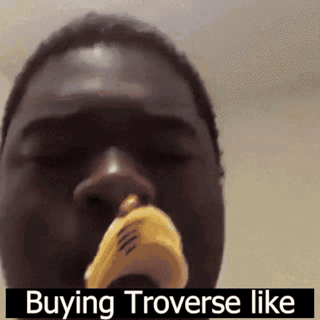 a close up of a man 's face with the words " buying trovese like " above it