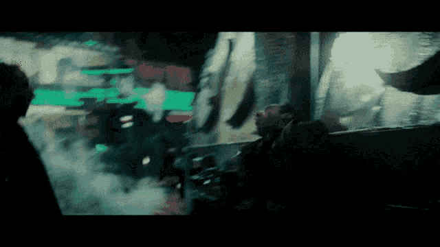a blurry picture of a man talking to another man