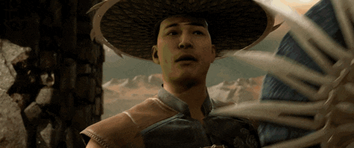 a man wearing a straw hat and a blue shirt