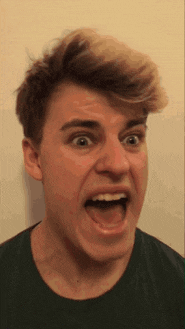 a young man is making a funny face with his mouth wide open