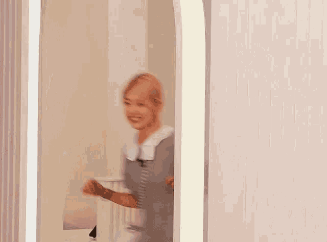a blurry picture of a woman standing in a doorway with korean writing on the wall .