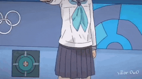 a girl in a school uniform is standing in front of a wall with olympic rings .