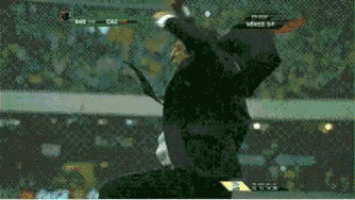 a man in a suit and tie is jumping in the air during a soccer match
