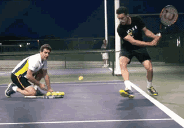 two men are playing tennis and one has a wilson racquet on