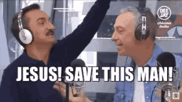 two men wearing headphones are standing in front of microphones and singing .