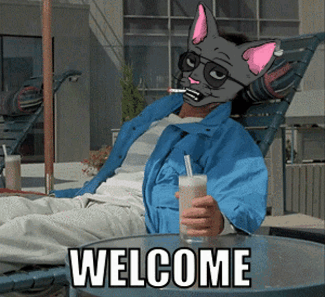 a man wearing a cat mask is sitting in a chair holding a drink and the words welcome are on the table