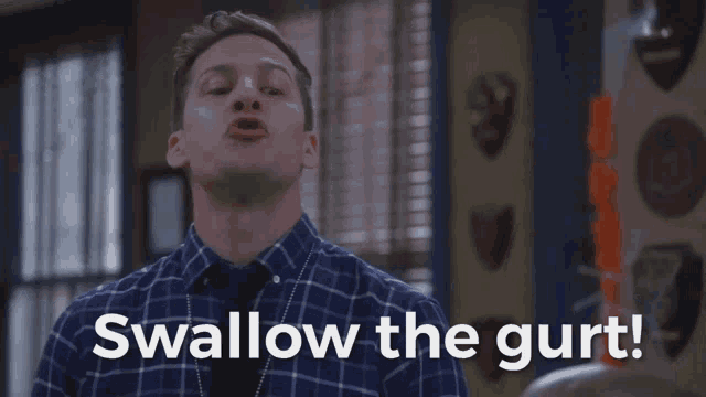 a man is saying swallow the gurt in a plaid shirt