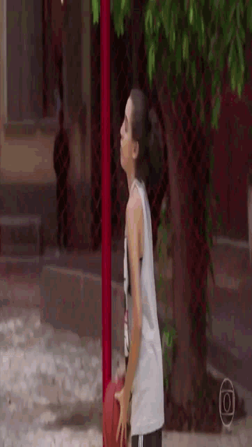 a woman in a white tank top with a picture of a bird on it