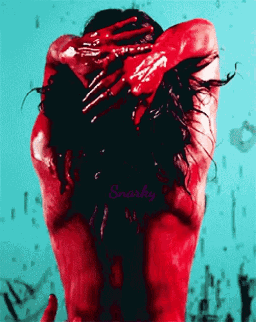 a woman is covered in red paint and the word smorky is on the bottom of the picture