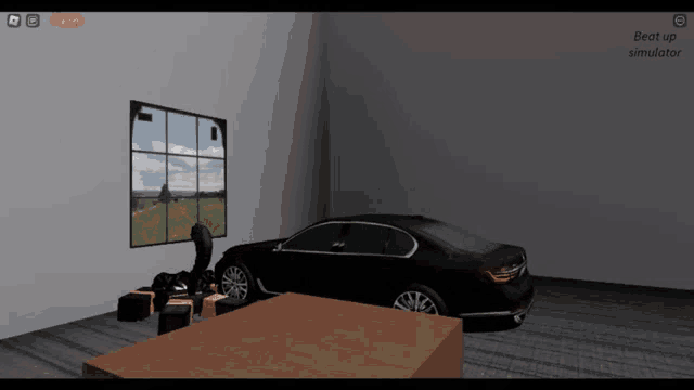 a black car is parked in a room next to a table and chairs