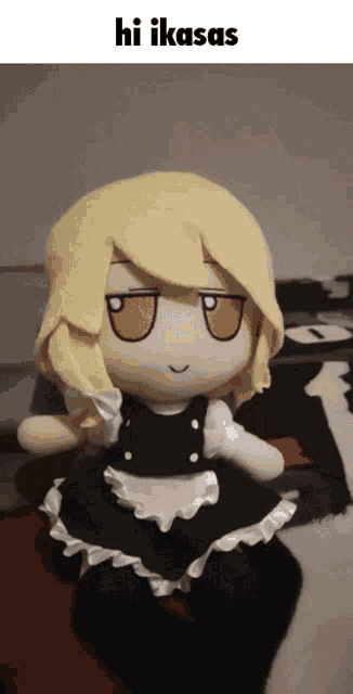 a stuffed doll in a maid outfit is sitting on a bed and says hi ikaas