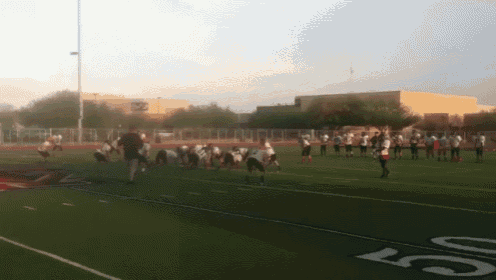 a football game is being played on a field with the number 50 on the sidelines