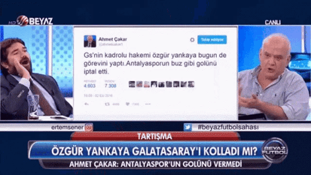 two men are sitting in front of a screen that says " canli "
