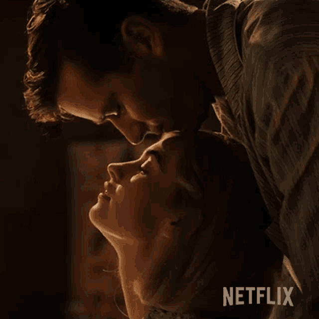 a man is kissing a woman on the forehead with a netflix logo in the background