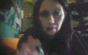 a blurry picture of a woman 's face with a hood on