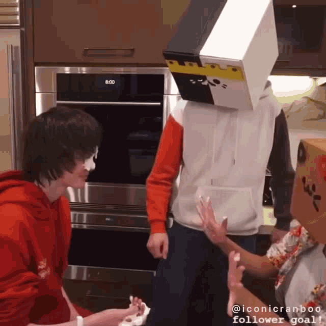 a person with a box on their head stands in front of a clock that says 8:00