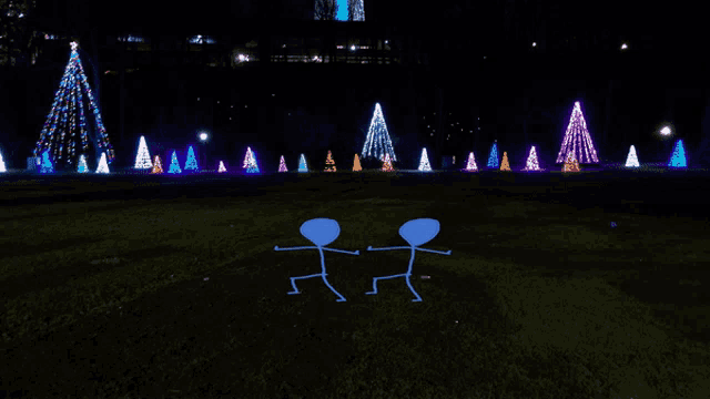 a couple of stick figures standing in front of a row of christmas trees