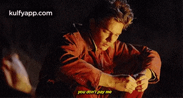 a man in a red jacket is sitting down and saying you don 't pay me .