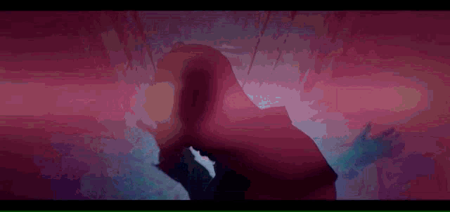 a man and woman are holding hands in a dark room