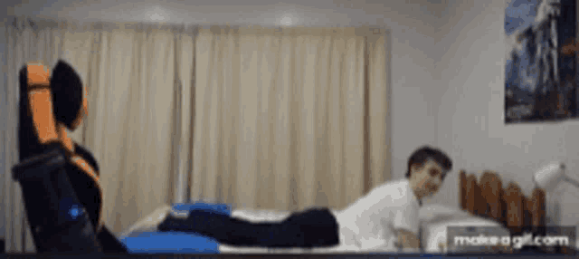 a person laying on a bed with a make-a-gif.com watermark on the bottom