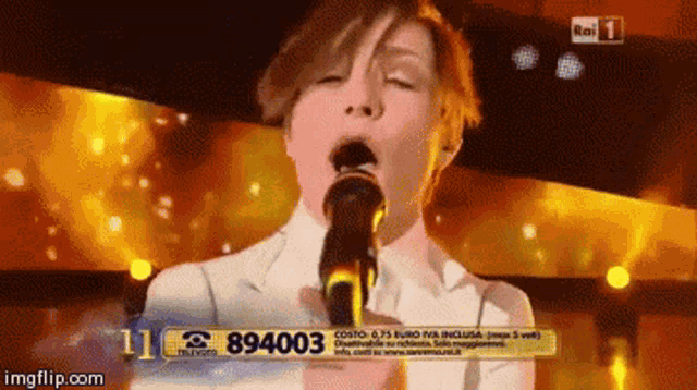 a woman singing into a microphone with the number 89400 on the bottom of the screen