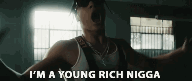 a man with sunglasses and a strap that says i 'm a young rich nigga