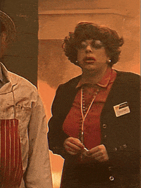 a woman in a red shirt and black jacket has a name tag that says susan