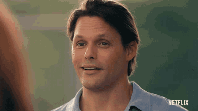 a man in a blue shirt is smiling in a netflix advertisement