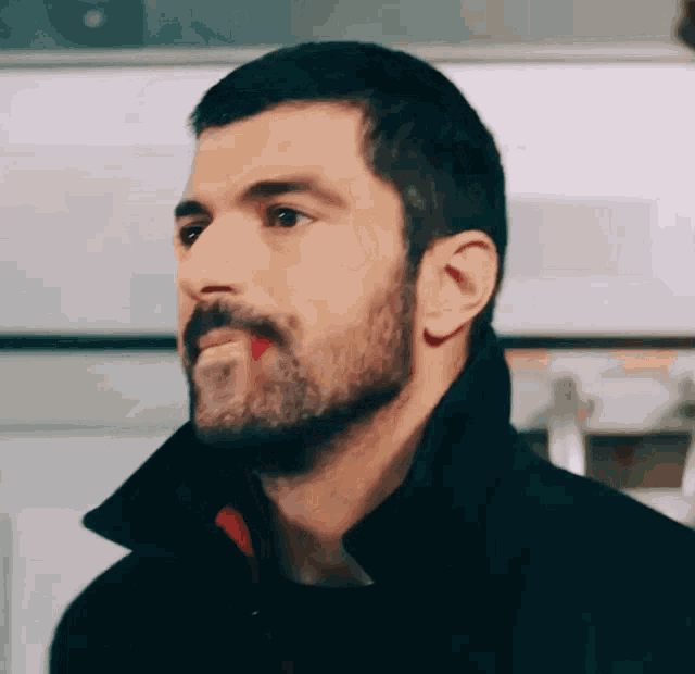a man with a beard and red lipstick on his face