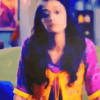a pixelated image of a woman in a purple and yellow shirt