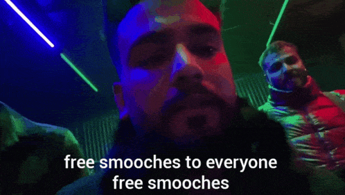 a man says " free smooches to everyone free smooches " in a dark room