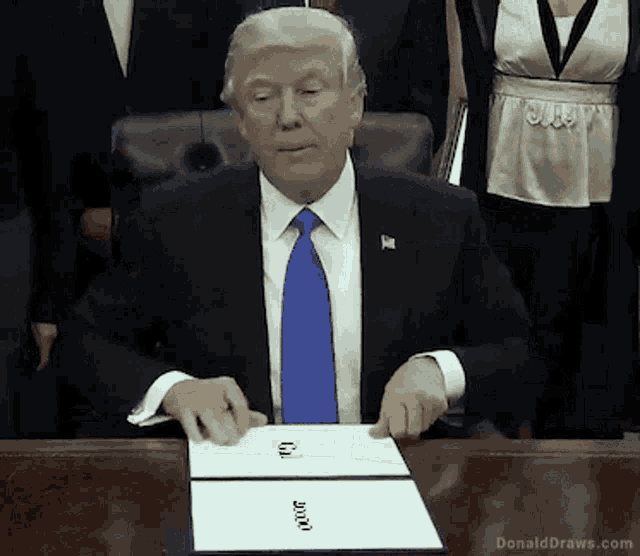 donald trump is sitting at a desk with a piece of paper that says " donald draws.com "