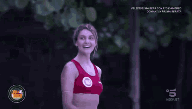 a woman wearing a red top with the number 5 on the bottom