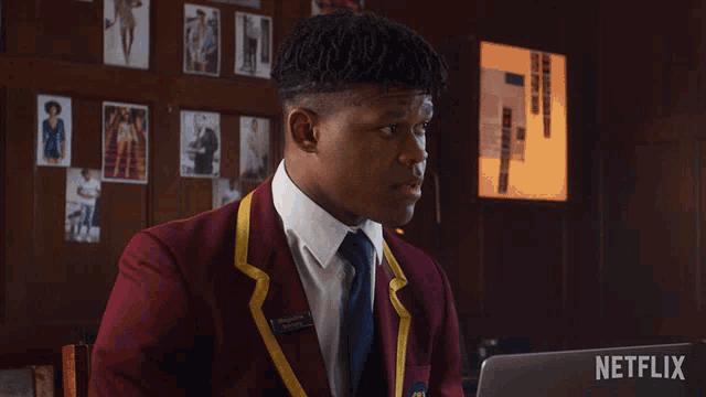a man in a red suit and tie says what in front of a netflix logo