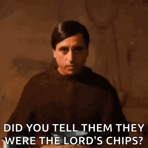 a man in a brown robe is sitting at a table and asking if they were lord 's chips .