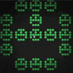 a computer screen displays a pattern of green circles with the letters eee on them