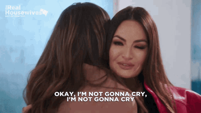 two women hugging with the words okay i 'm not gonna cry