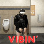 a man in a helmet is standing in a bathroom with the words vibin ' on the floor