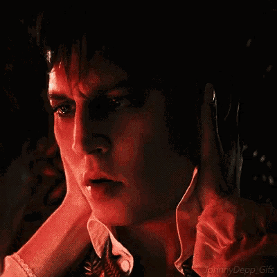 a close up of a man 's face with the words johnny depp gifs on the bottom right