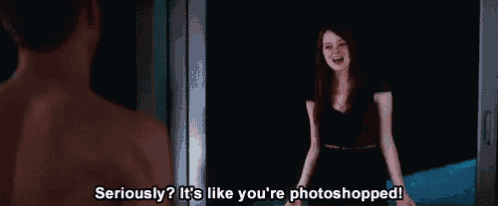 a woman in a black dress is standing in front of a man in a dark room .