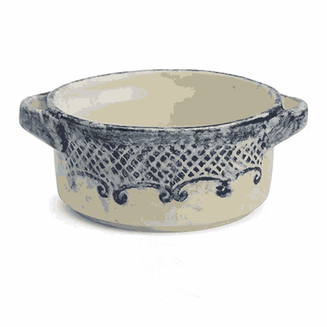 a metal bucket with handles on a white surface
